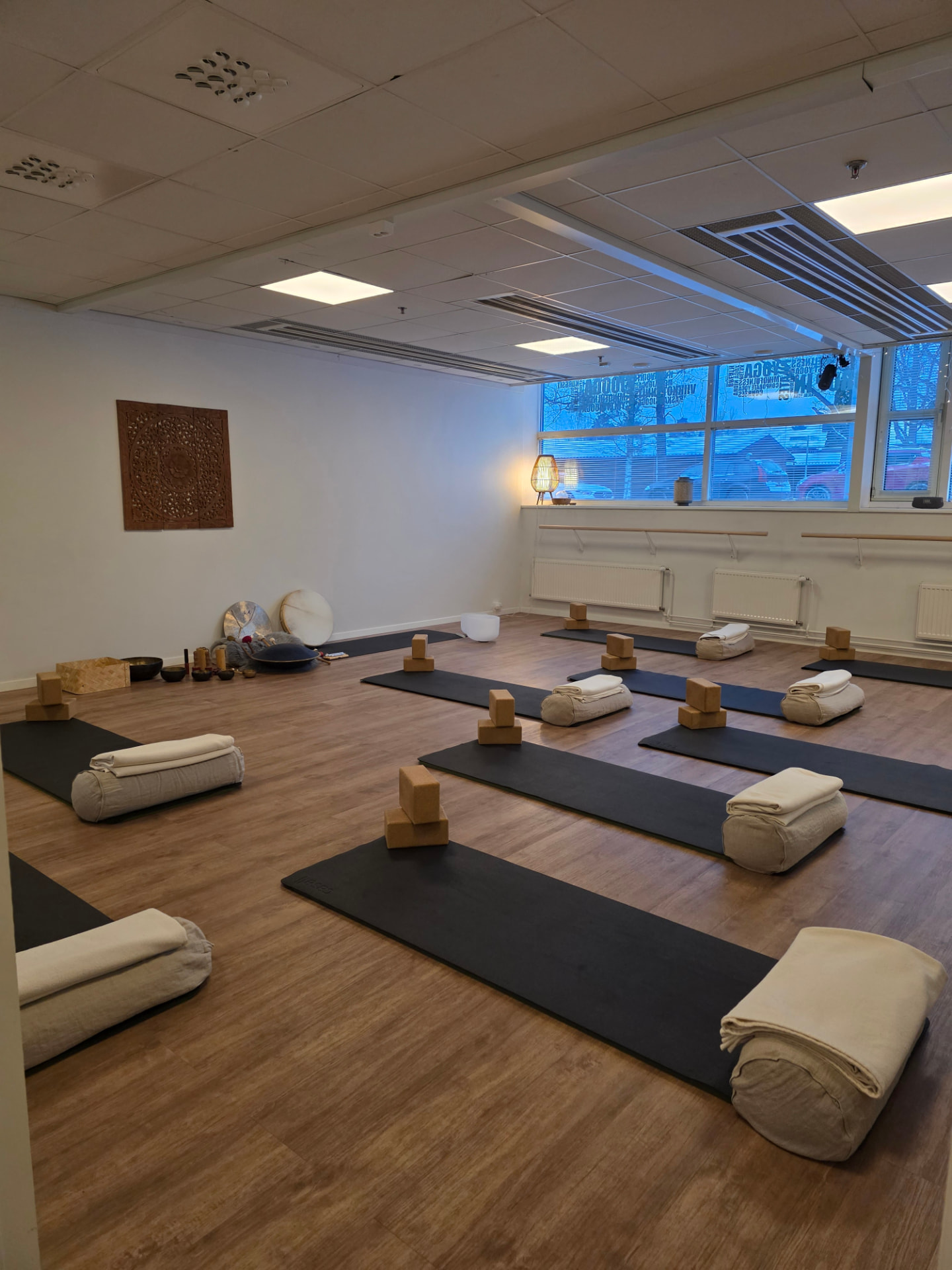 A calm retreat space prepared with mats, cork blocks and bolsters